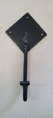 Black hook riveted to black diamond-shaped backing plate.