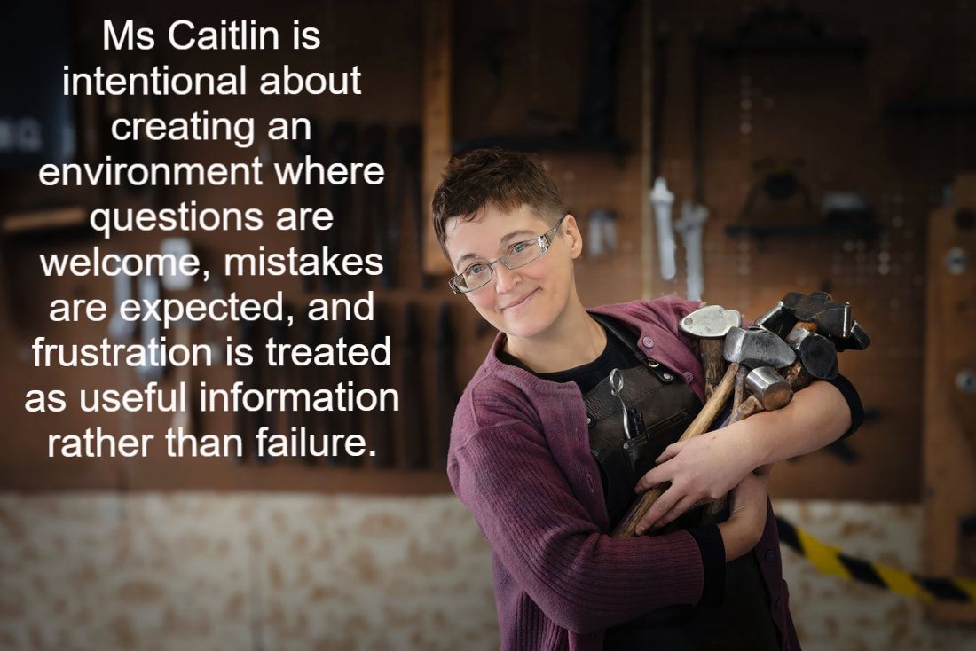 Ms Caitlin holds an armful of hammers next to white text that reads: 