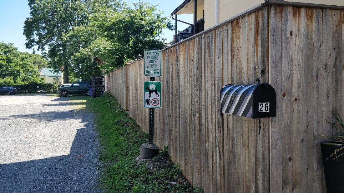 The street view of 26 West All Saints Street: a purple, black, and silver striped mailbox labeled 